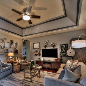 Marchant living room with sofa, fan, tv and tables